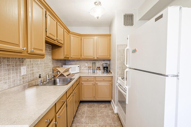 kitchen with light brown cabinets, white appliances, sink, decorative backsplash, and light tile patterned flooring