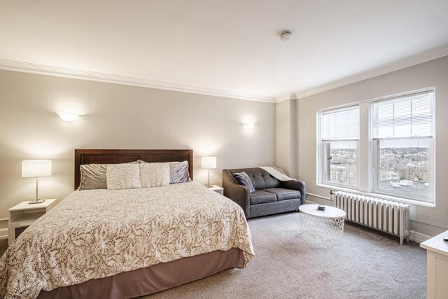 carpeted bedroom featuring radiator heating unit and ornamental molding