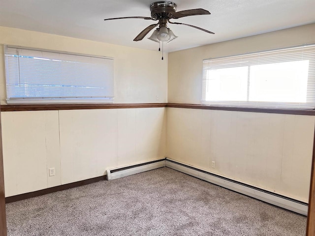 unfurnished room with ceiling fan, light colored carpet, and a baseboard radiator