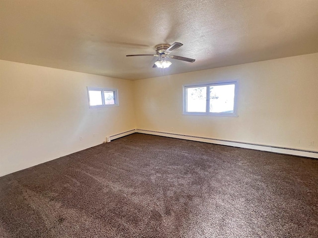 carpeted empty room featuring plenty of natural light, ceiling fan, a textured ceiling, and a baseboard radiator