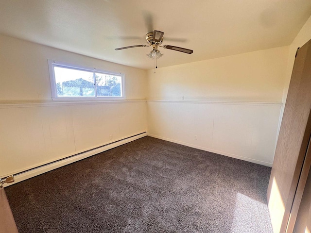 spare room featuring a baseboard radiator, dark carpet, and ceiling fan