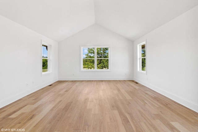 unfurnished room with light hardwood / wood-style flooring and lofted ceiling