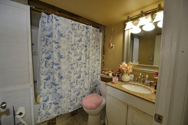 full bathroom featuring tile patterned floors, vanity, shower / bath combination with curtain, and toilet