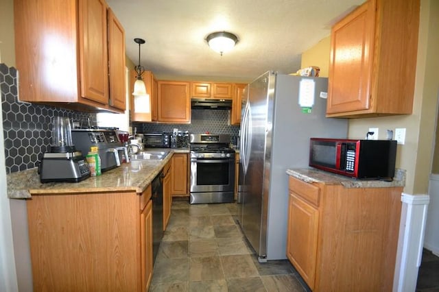 kitchen with black appliances, decorative light fixtures, backsplash, and sink