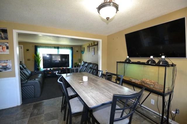 dining area featuring a textured ceiling