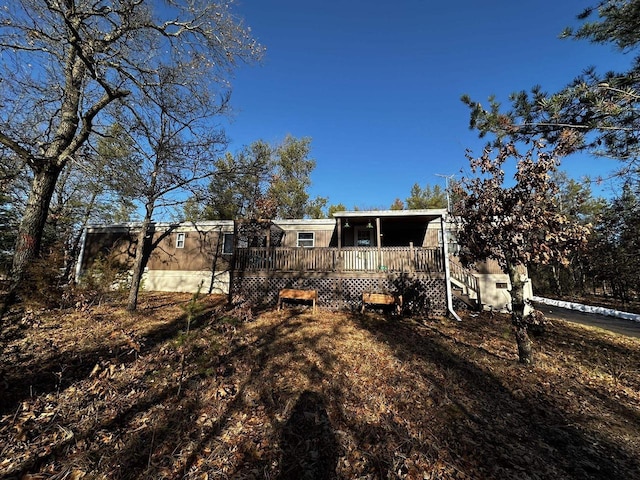 back of property with a wooden deck