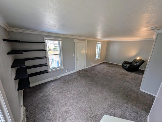 carpeted foyer featuring a textured ceiling and ornamental molding