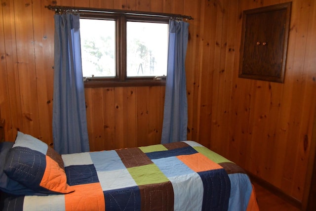 bedroom featuring wood walls