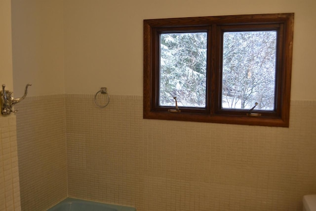 bathroom with tile walls