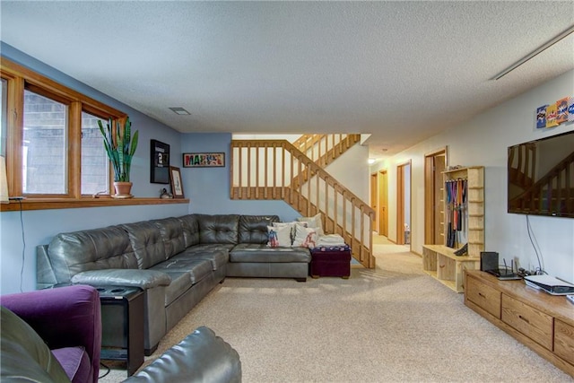 living room with light carpet and a textured ceiling