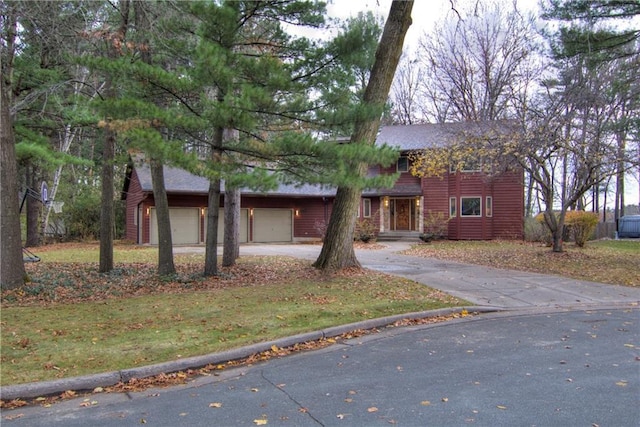 view of front of property with a front lawn and a garage