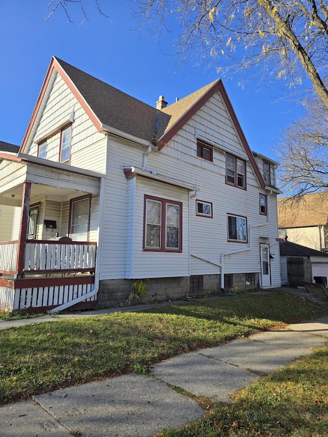 view of home's exterior featuring a lawn and a porch