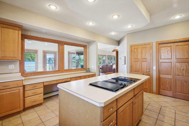 kitchen with black electric stovetop, a center island, light tile patterned floors, and a baseboard heating unit