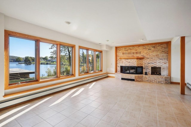 unfurnished living room featuring a water view, light tile patterned floors, a fireplace, and a baseboard heating unit