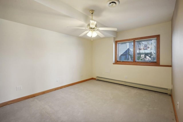 carpeted spare room featuring ceiling fan and a baseboard heating unit