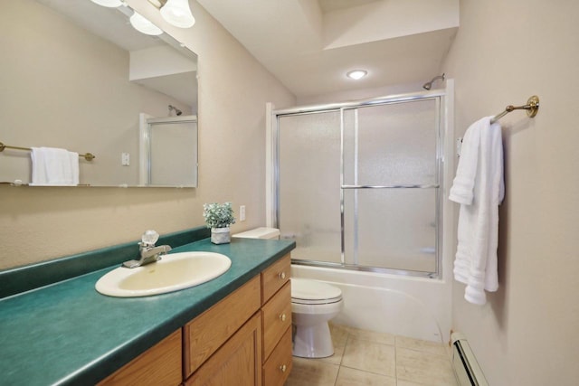 full bathroom featuring vanity, a baseboard heating unit, tile patterned floors, toilet, and enclosed tub / shower combo