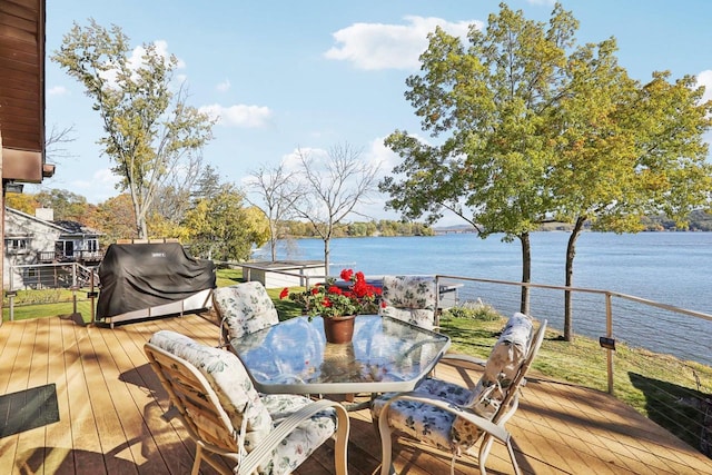 wooden terrace with a water view and grilling area