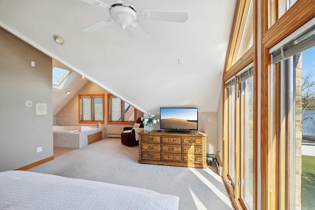 carpeted bedroom with baseboard heating, a skylight, ceiling fan, and high vaulted ceiling