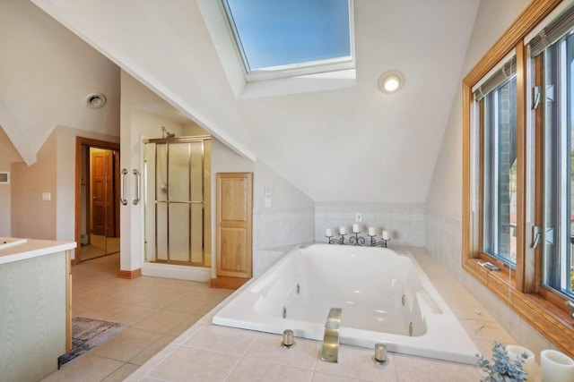 bathroom featuring lofted ceiling with skylight and a healthy amount of sunlight