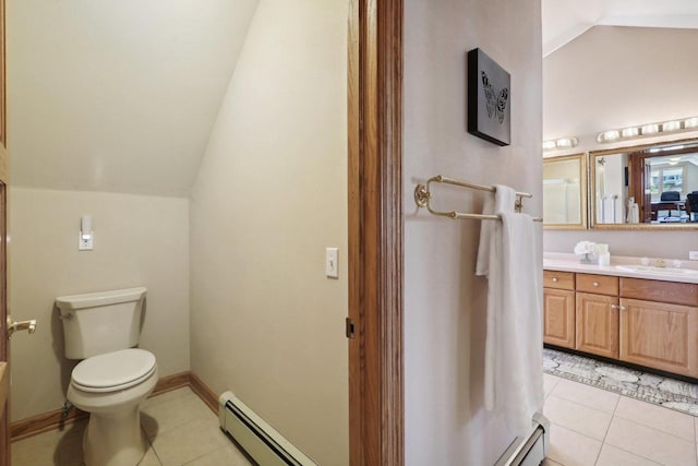 bathroom with baseboard heating, tile patterned floors, vaulted ceiling, toilet, and vanity