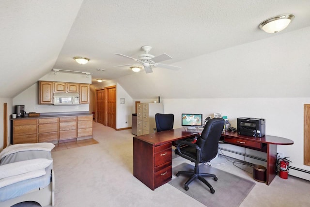 carpeted office featuring a textured ceiling, vaulted ceiling, and ceiling fan