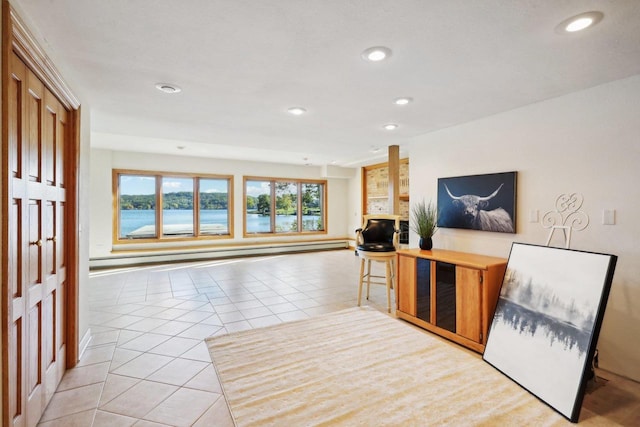 interior space featuring baseboard heating and a water view