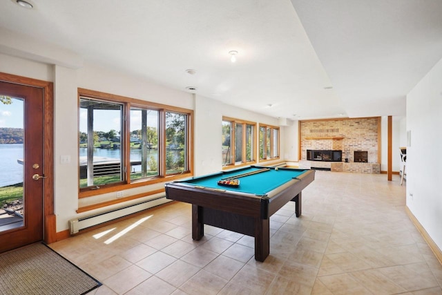 game room featuring pool table, a baseboard radiator, a water view, a fireplace, and light tile patterned flooring