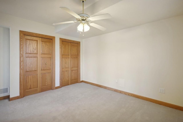 unfurnished bedroom with ceiling fan and light carpet