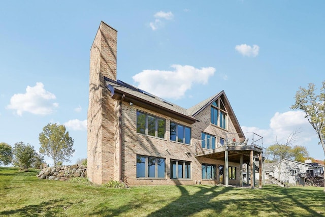 back of property featuring a lawn and a wooden deck