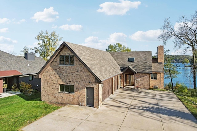 tudor-style house with a water view and a garage