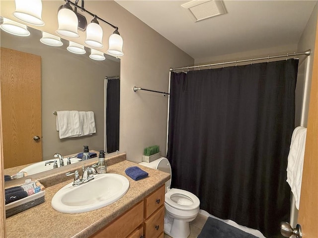 bathroom featuring tile patterned flooring, vanity, and toilet