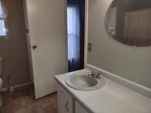 bathroom with plenty of natural light, vanity, and toilet