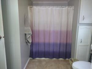 bathroom with toilet and ornamental molding