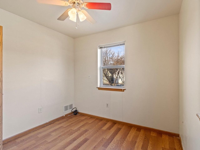 empty room featuring ceiling fan and light wood-type flooring