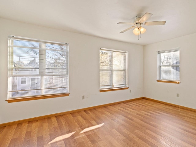 unfurnished room with plenty of natural light, light hardwood / wood-style floors, and ceiling fan