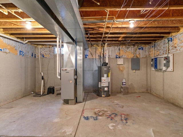 basement with electric panel, heating unit, and water heater