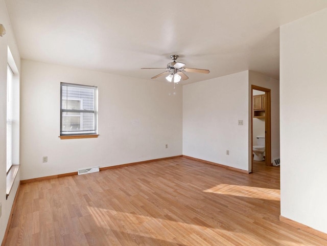 spare room featuring ceiling fan and light hardwood / wood-style floors