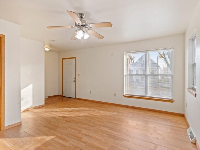 unfurnished room with ceiling fan and light wood-type flooring