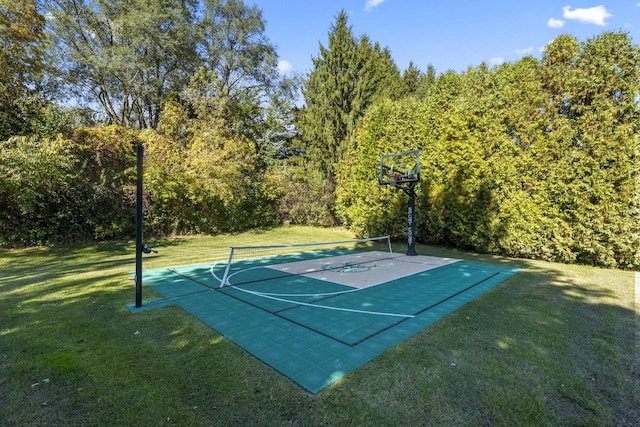 view of basketball court with a yard