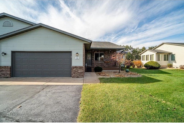 single story home with a porch, a garage, and a front lawn