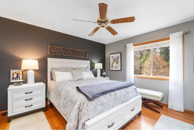 bedroom with light wood-type flooring and ceiling fan