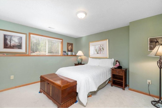 carpeted bedroom featuring a textured ceiling