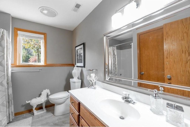 bathroom with tile patterned flooring, vanity, toilet, and curtained shower