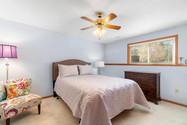 carpeted bedroom with a textured ceiling and ceiling fan