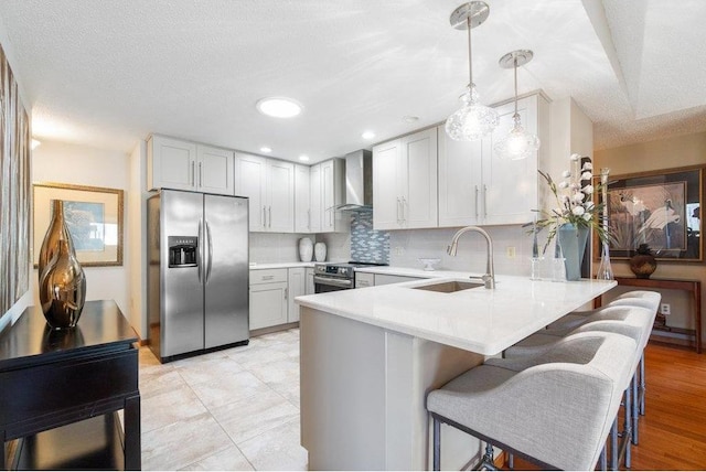 E5745 816th Ave, Colfax, WI 54730 - kitchen with appliances with stainless steel finishes, a sink, wall chimney range hood, a peninsula, and light countertops
