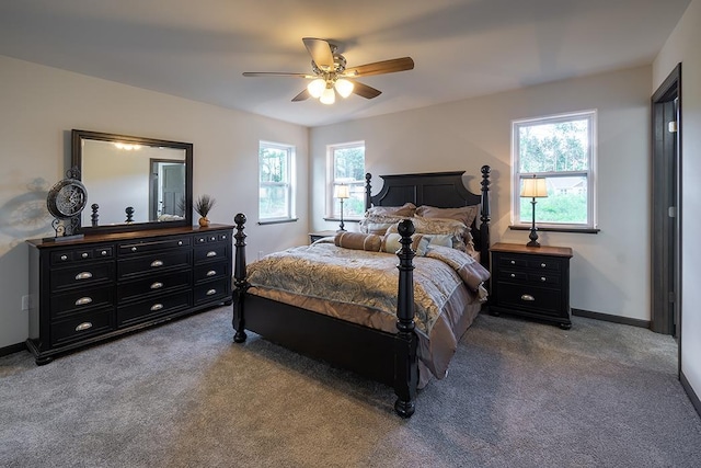 carpeted bedroom featuring ceiling fan and multiple windows