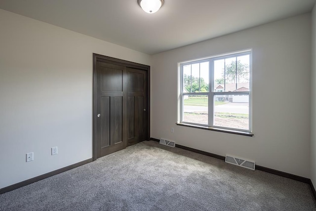 unfurnished bedroom featuring light carpet