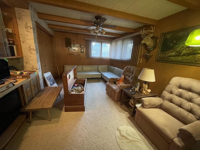 sitting room featuring beamed ceiling and ceiling fan