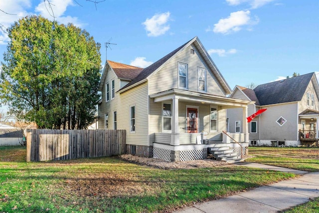 view of front of property with covered porch and a front yard