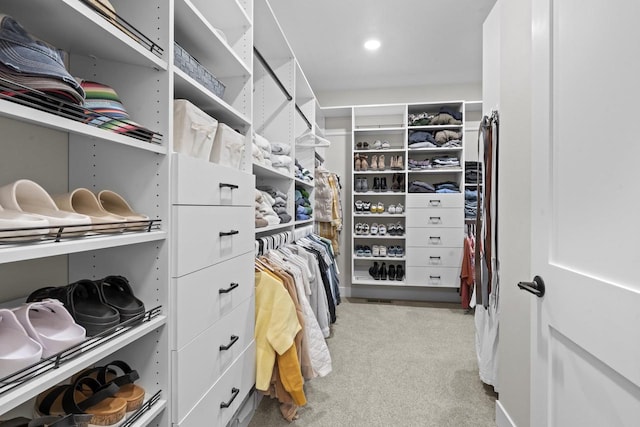 walk in closet featuring light carpet